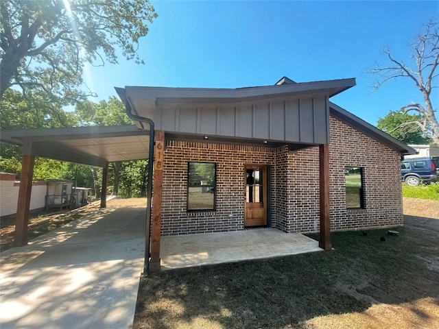 back of house with a carport