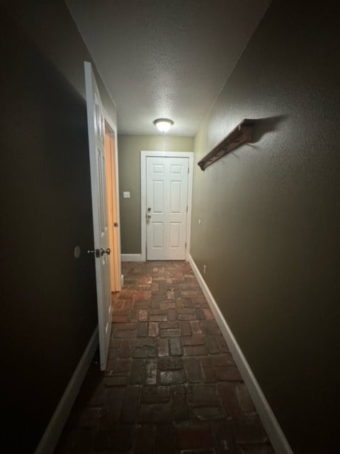 hall with a textured ceiling