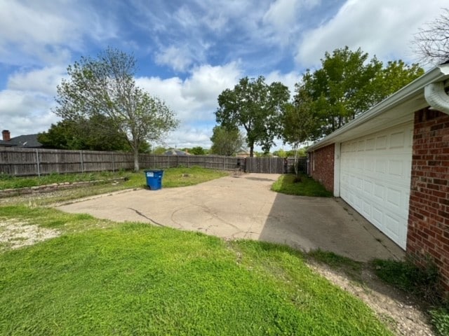 view of yard featuring a patio area and a garage