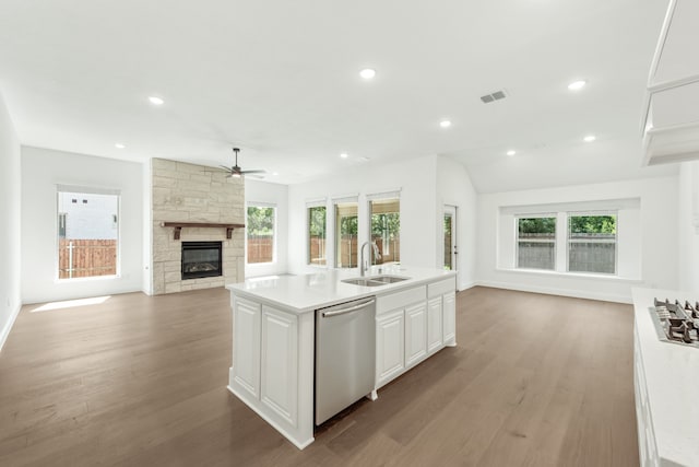 kitchen featuring an island with sink, sink, white cabinetry, and dishwasher