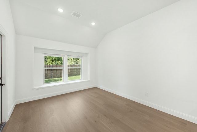 carpeted empty room with vaulted ceiling and ceiling fan