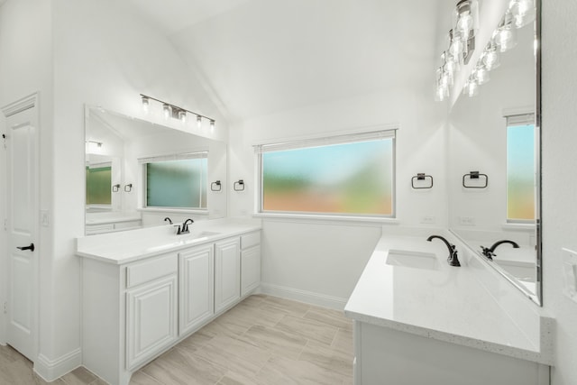 bathroom with vanity, lofted ceiling, and a chandelier