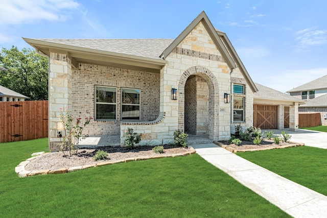 view of front of home featuring a garage and a front lawn