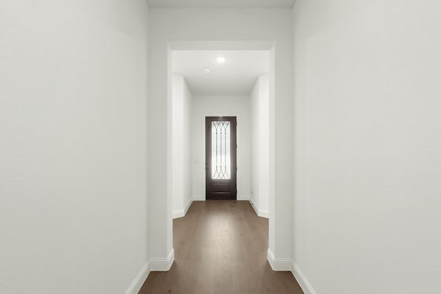 hallway with wood-type flooring