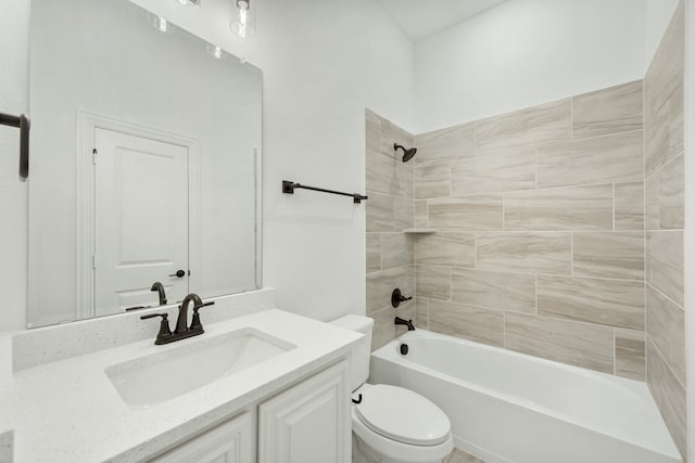 full bathroom with vanity, tiled shower / bath combo, and toilet