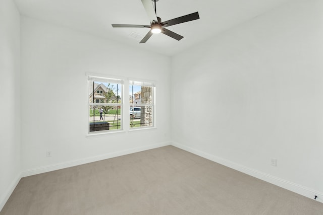 carpeted spare room with ceiling fan