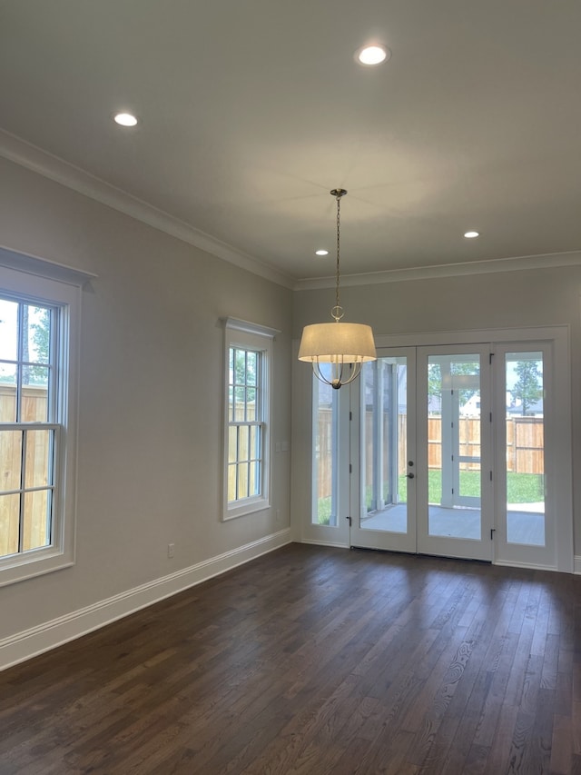 interior space with baseboards, dark wood-type flooring, a healthy amount of sunlight, and ornamental molding