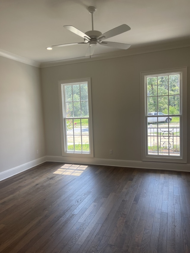 unfurnished room featuring baseboards, dark wood-type flooring, and ornamental molding