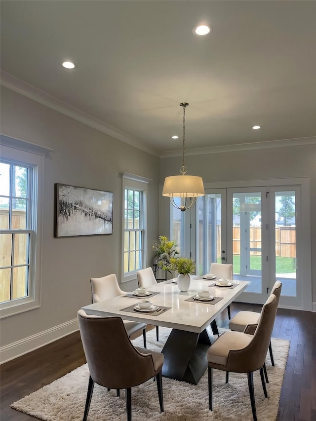 dining room featuring dark wood finished floors, crown molding, recessed lighting, and baseboards