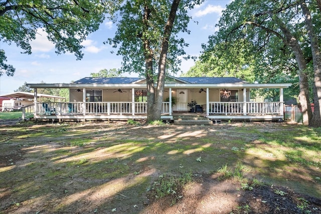 ranch-style house with ceiling fan and a porch