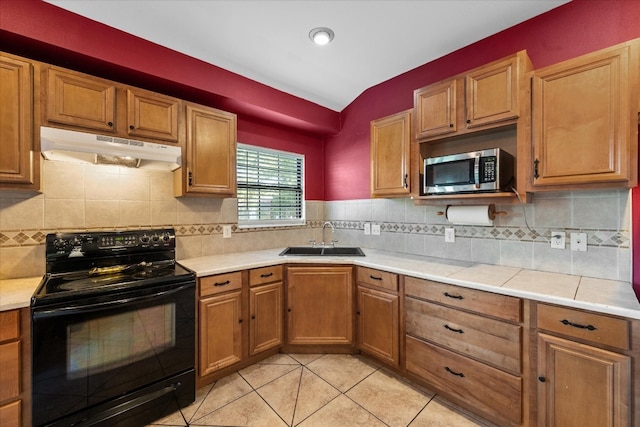 kitchen featuring black electric range oven, light tile floors, sink, tasteful backsplash, and lofted ceiling