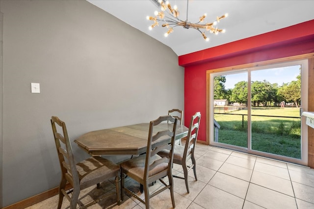 dining area featuring lofted ceiling, light tile floors, and a chandelier