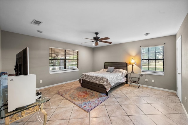 tiled bedroom featuring ceiling fan