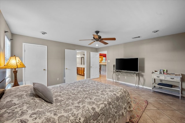 bedroom with tile flooring, ceiling fan, and ensuite bath