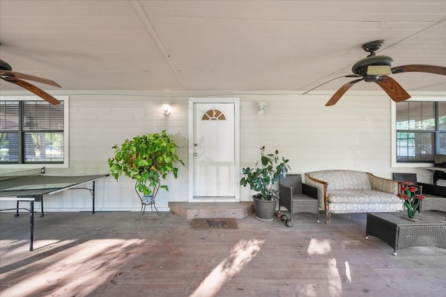 doorway to property with ceiling fan and an outdoor hangout area