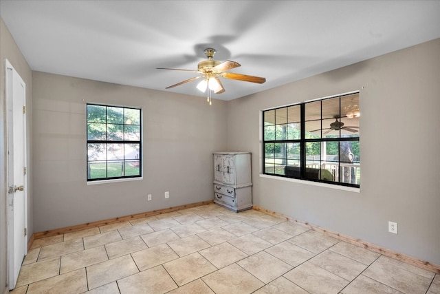 tiled empty room with ceiling fan