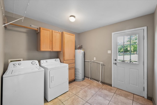 clothes washing area featuring water heater, independent washer and dryer, and light tile flooring