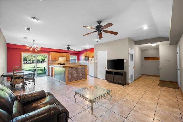 unfurnished living room with ceiling fan with notable chandelier and light tile floors