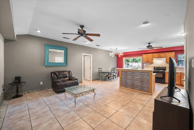 living room with ceiling fan with notable chandelier and light tile floors