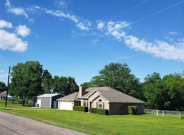 ranch-style home with a front yard and a garage