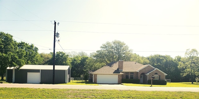 ranch-style home with a front lawn and a garage