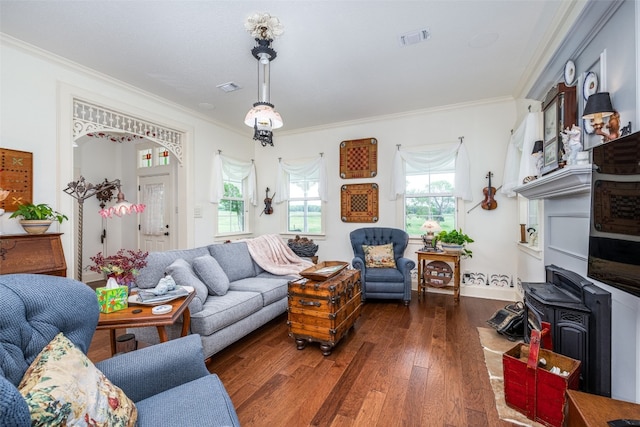 living room featuring ornamental molding and dark hardwood / wood-style flooring