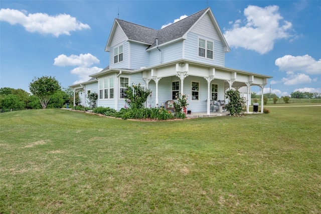 back of house featuring a yard and a porch