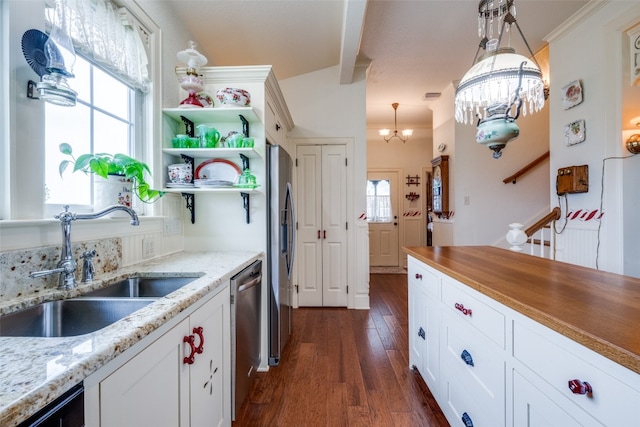 kitchen featuring hanging light fixtures, dark hardwood / wood-style floors, sink, and white cabinetry