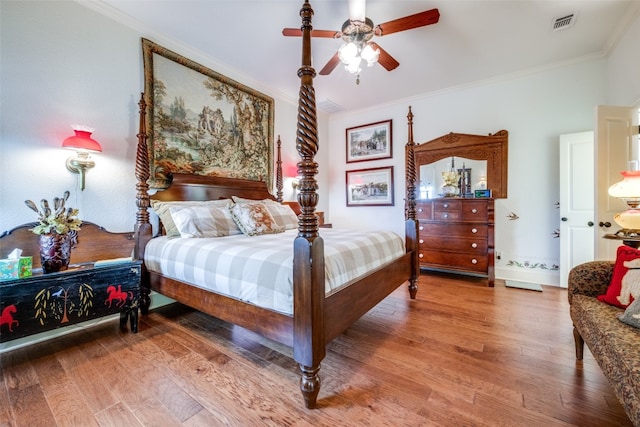 bedroom featuring ornamental molding, wood-type flooring, and ceiling fan