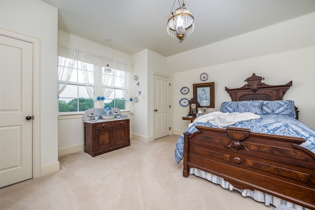 carpeted bedroom featuring lofted ceiling and an inviting chandelier