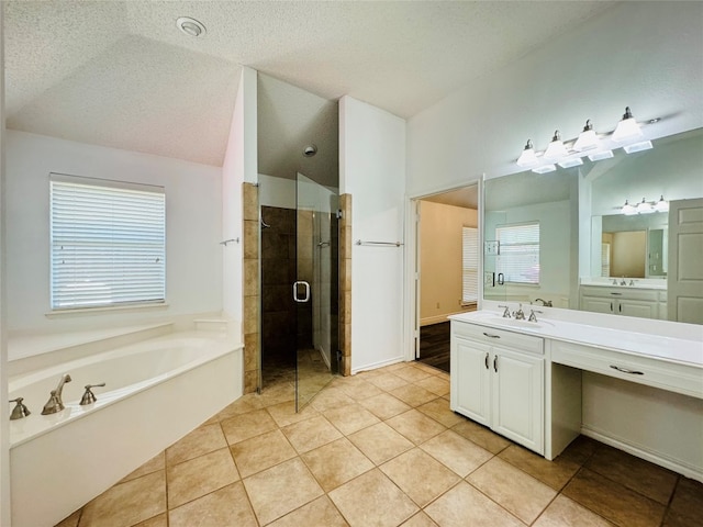 bathroom featuring separate shower and tub, a textured ceiling, oversized vanity, lofted ceiling, and tile floors