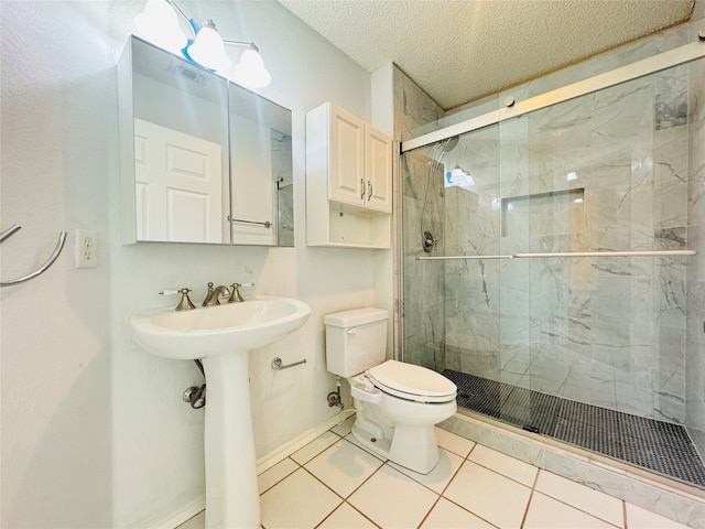 bathroom with a textured ceiling, a shower with shower door, tile floors, and toilet