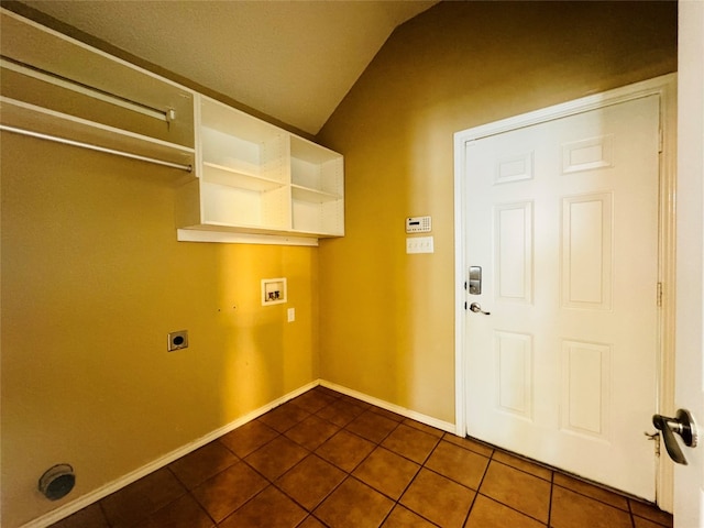 washroom with washer hookup, dark tile floors, and electric dryer hookup