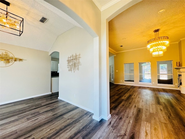 spare room featuring ornamental molding, dark hardwood / wood-style flooring, and a textured ceiling