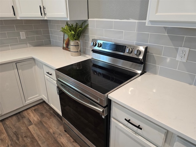 kitchen with white cabinets, tasteful backsplash, stainless steel electric range, and dark hardwood / wood-style floors