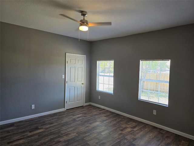 unfurnished room featuring ceiling fan and dark hardwood / wood-style flooring