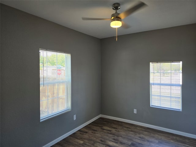 unfurnished room with dark hardwood / wood-style floors and ceiling fan