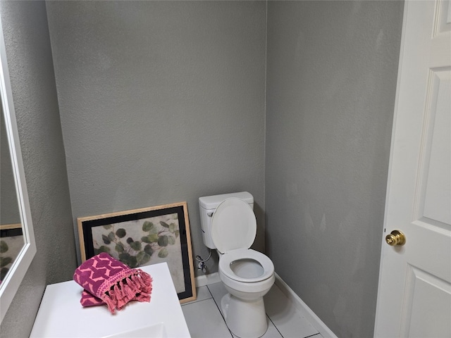 bathroom featuring toilet and tile flooring