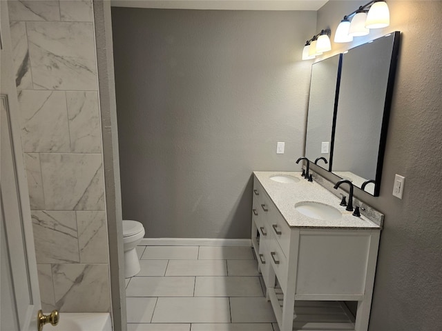 bathroom featuring large vanity, toilet, double sink, and tile flooring