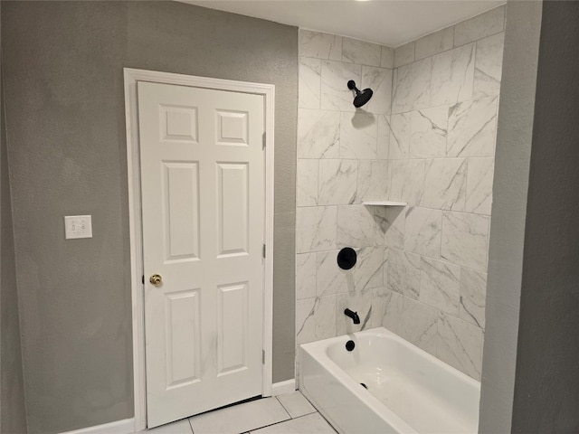 bathroom featuring tile flooring and tiled shower / bath