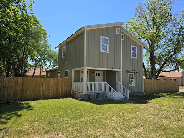 rear view of house with a yard