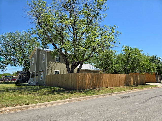 view of side of property with a yard