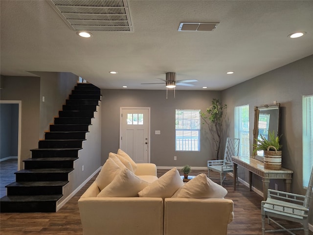 living room with ceiling fan, dark hardwood / wood-style floors, and plenty of natural light