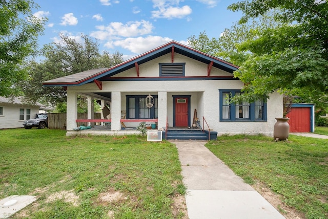 bungalow-style house with a front yard and covered porch