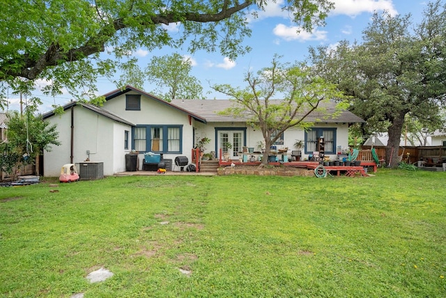 rear view of house with a yard and central air condition unit