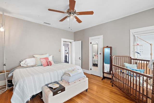 bedroom with ceiling fan and light hardwood / wood-style floors