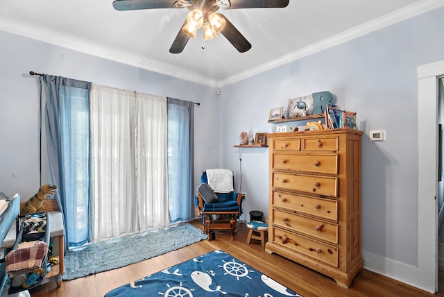 sitting room with hardwood / wood-style floors, ceiling fan, and ornamental molding