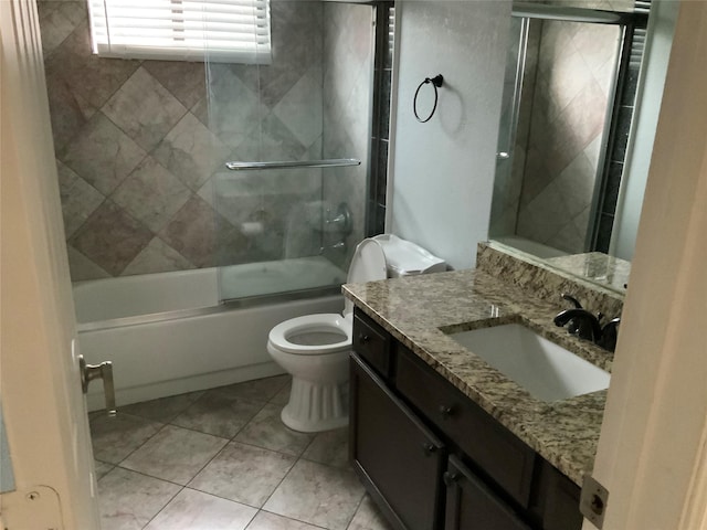 full bathroom featuring tile patterned flooring, vanity, enclosed tub / shower combo, and toilet