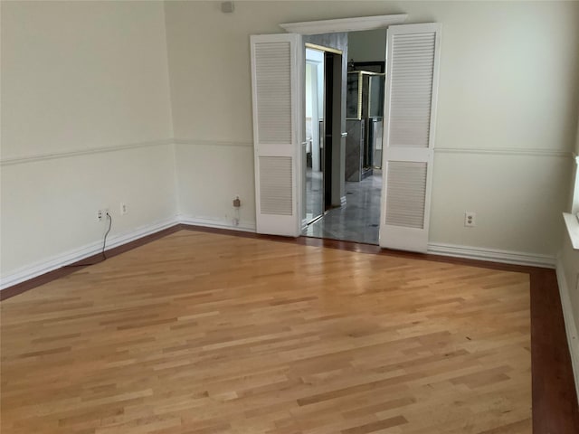 spare room with light wood-type flooring