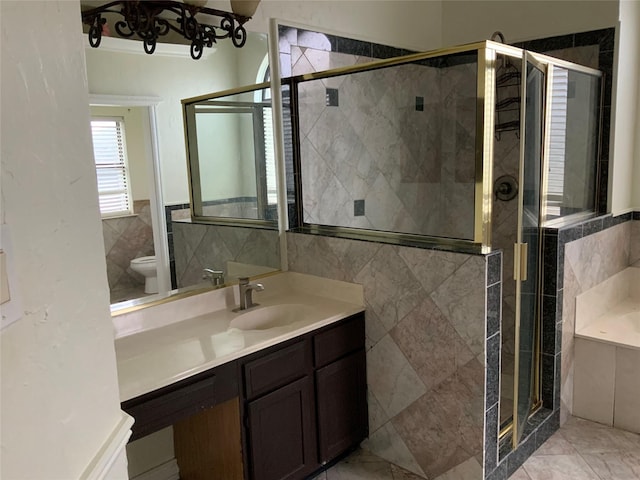 full bathroom with separate shower and tub, vanity, tile walls, and toilet